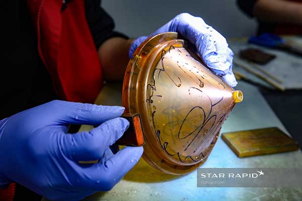 Wet sanding of chamber parts; black markers indicate untouched areas